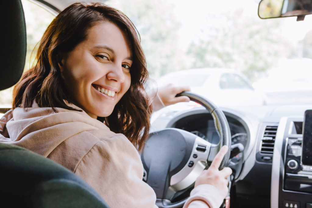 young pretty driver woman sitting in car